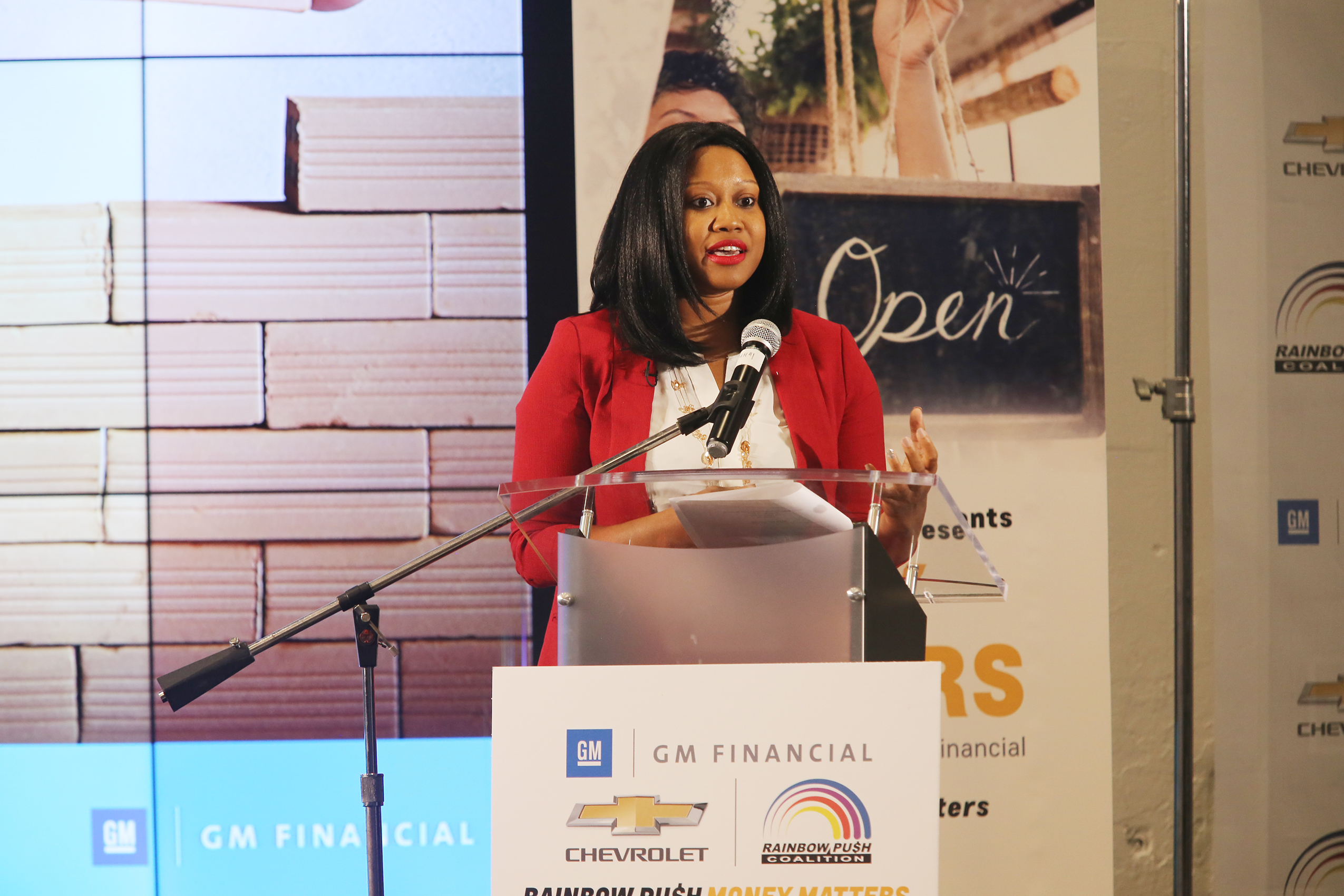 Woman in red jacket at podium during Money Matters